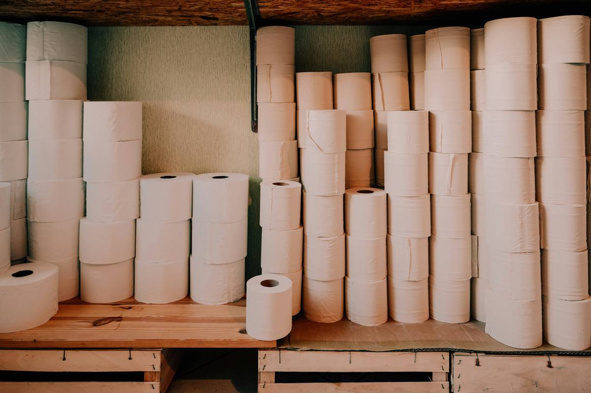 Side-by-side comparison showing regular toilet paper clumping after 5 minutes in water vs. biodegradable toilet paper fully dissolving